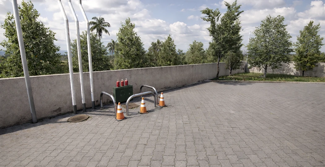 Open parking area bordered by trees and concrete walls